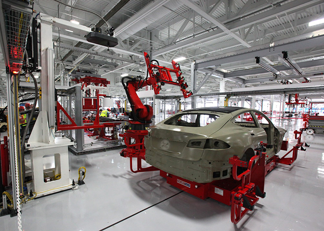 Robots welding a car on a production line