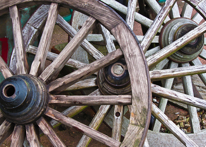 A pile of cart wheels